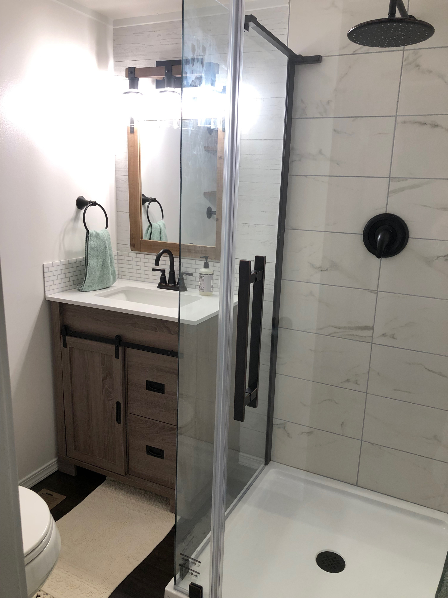Bathroom remodel with tile shower and matte black fixtures
